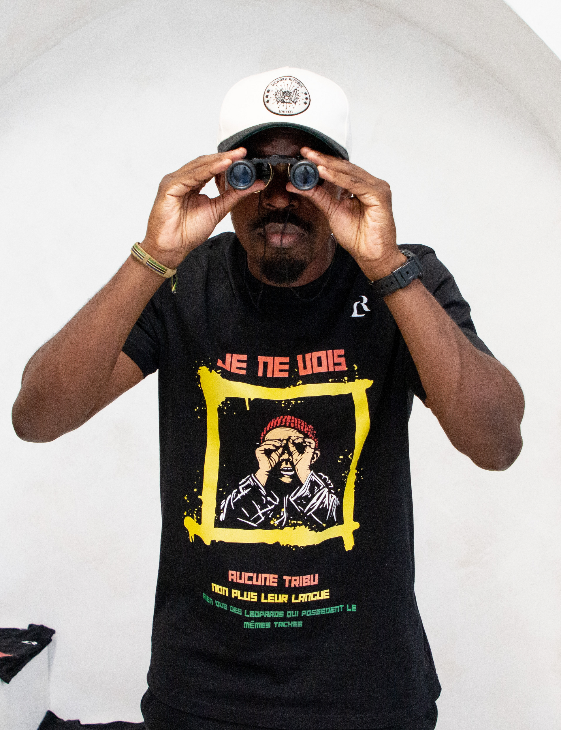 Leopard Republic's DRC "A Tribe Called Leopard Republic" front side with model using binoculars. 